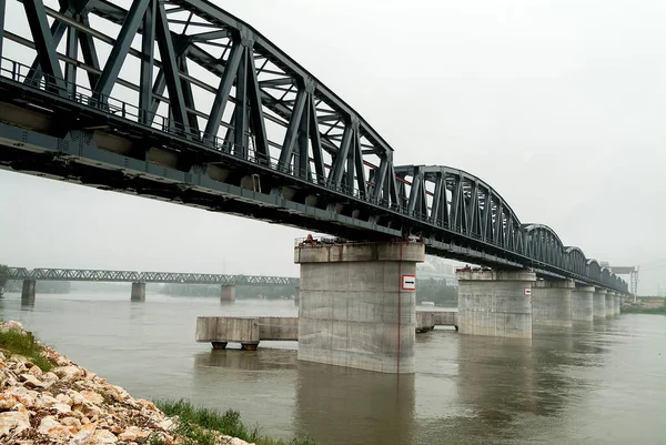 Perspective view of Iron bridge on concrete piers over the river