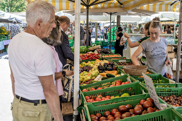 Graz, Austria - August 26, 2023: Stall with vegetables greens and fruit at the farmer's market in Kaiser-Josef-Platz