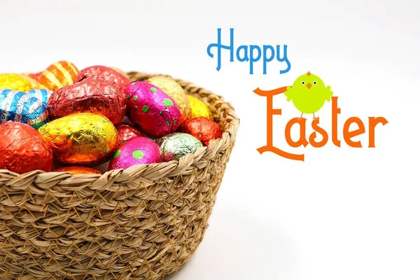 stock image Basket of chocolate Easter eggs, isolated on a white background. Text 'Happy Easter'. Copy space.