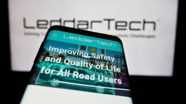 Stuttgart, Germany - 05-06-2024: Mobile phone with webpage of Canadian lidar company LeddarTech Holdings Inc. in front of business logo. Focus on top-left of phone display. clipart