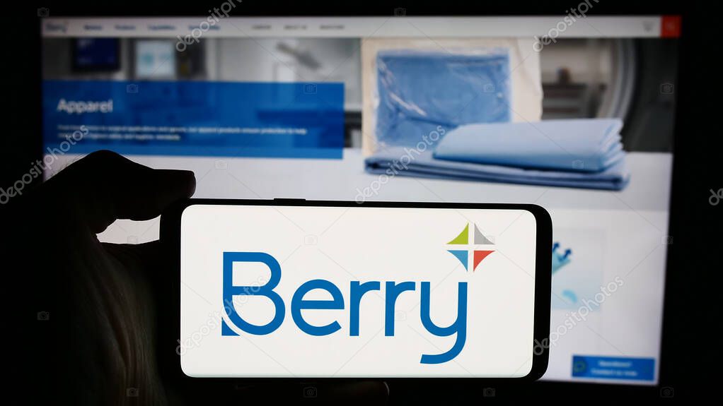 Stuttgart, Germany - 05-06-2024: Person holding cellphone with logo of US plastic packaging company Berry Global Group Inc. in front of business webpage. Focus on phone display.