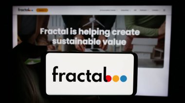 Stuttgart, Germany - 05-08-2024: Person holding cellphone with logo of artificial intelligence company Fractal Analytics Pvt. Ltd. in front of webpage. Focus on phone display. clipart