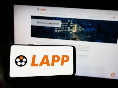 Stuttgart, Almanya - 05-24-2024: Alman kablo şirketi Lapp Holding SE 'nin logosunun bulunduğu akıllı telefonu web sitesinin önünde tutan kişi. Telefon ekranına odaklan.