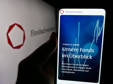 Stuttgart, Almanya - 05-24-2024: Alman zenginlik yönetimi şirketi Flossbach von Storch AG 'nin logolu internet sitesi ile akıllı telefon sahibi kişi. Telefon ekranının merkezine odaklan.