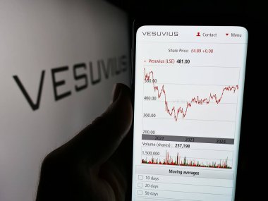 Stuttgart, Almanya - 05-30-2024: İngiliz mühendislik şirketi Vesuvius plc 'nin web sitesi ile logo önünde cep telefonu tutan kişi. Telefon ekranının merkezine odaklan.