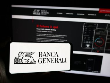 Stuttgart, Almanya - 06-01-2024: İtalyan finans hizmetleri şirketi Banca Generali S.P.A. 'nın logosunun bulunduğu cep telefonu sahibi kişi web sitesinin önünde. Telefon ekranına odaklan.