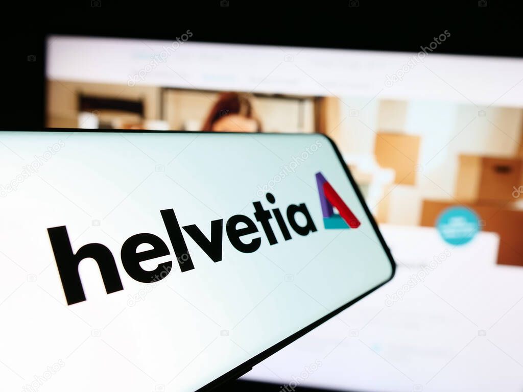 Stuttgart, Germany - 05-31-2024: Mobile phone with logo of Swiss insurance company Helvetia Holding AG in front of business website. Focus on center-left of phone display.
