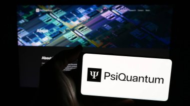 Stuttgart, Germany - 06-05-2024: Person holding smartphone with logo of US quantum computing company PsiQuantum Corp. in front of website. Focus on phone display. clipart