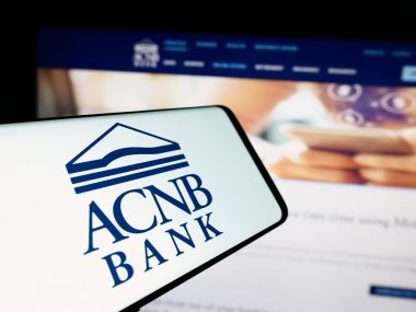 Stuttgart, Almanya - 07-03-2024: Amerikan finans hizmetleri şirketi ACNB Corporation 'ın logosunu taşıyan cep telefonu iş web sitesi önünde. Telefon ekranının merkez sağına odaklan.
