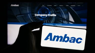 Stuttgart, Almanya - 07-03-2024: İnternet sitesi önünde ABD 'li finans şirketi Ambac Financial Group Inc.' in logosuna sahip kişi. Telefon ekranına odaklan.
