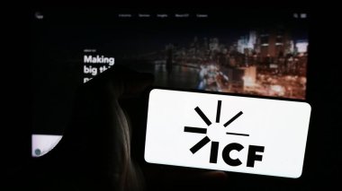 Stuttgart, Almanya - 07-06-2024: İnternet sitesi önünde ABD 'li danışmanlık şirketi ICF International Inc.' nin logosuna sahip kişi. Telefon ekranına odaklan.