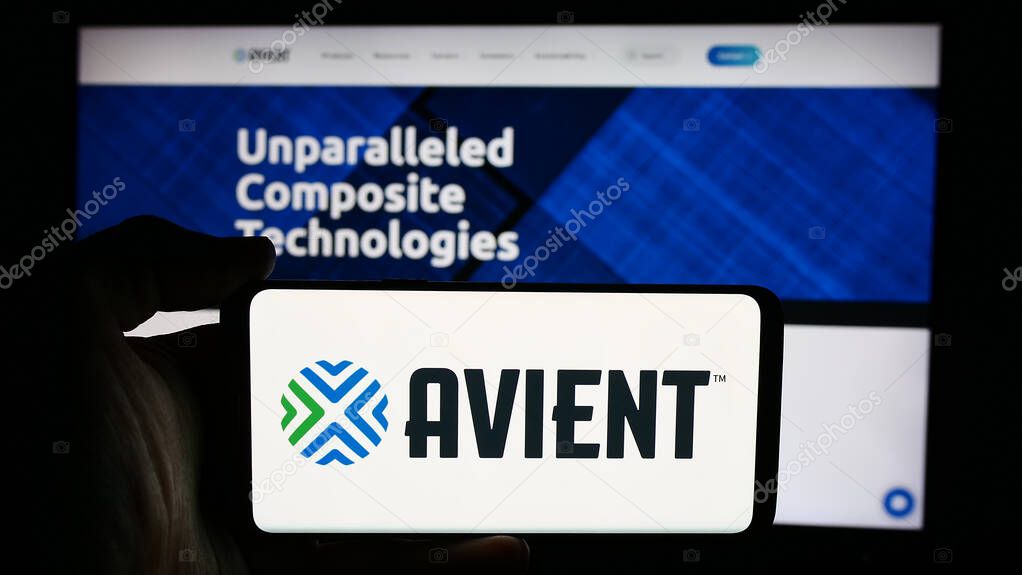 Stuttgart, Germany - 07-03-2024: Person holding cellphone with logo of US polymer materials company Avient Corporation in front of business webpage. Focus on phone display.