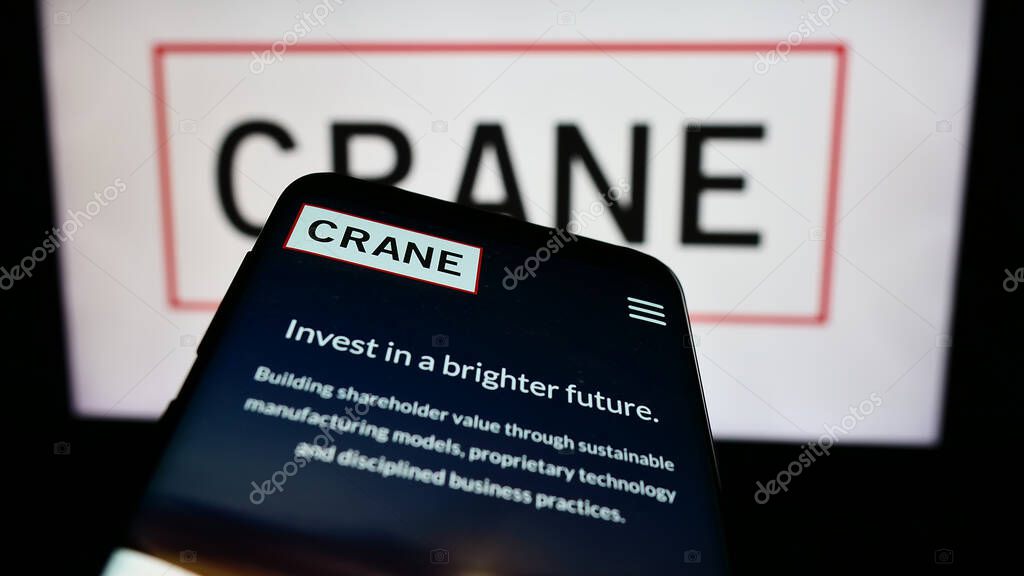 Stuttgart, Germany - 07-04-2024: Mobile phone with website of US industrial products company Crane Co. in front of business logo. Focus on top-left of phone display.
