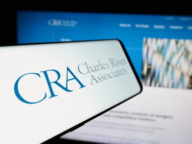 Stuttgart, Germany - 07-06-2024: Smartphone with logo of US company CRA International Inc. (Charles River Associates) in front of website. Focus on left of phone display. clipart