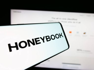 Stuttgart, Almanya - 07-14-2024: İnternet sitesi önünde Amerikan müşteri hizmetleri yönetim şirketi HoneyBook Inc. 'in logosuna sahip cep telefonu. Telefon ekranının merkez soluna odaklan.