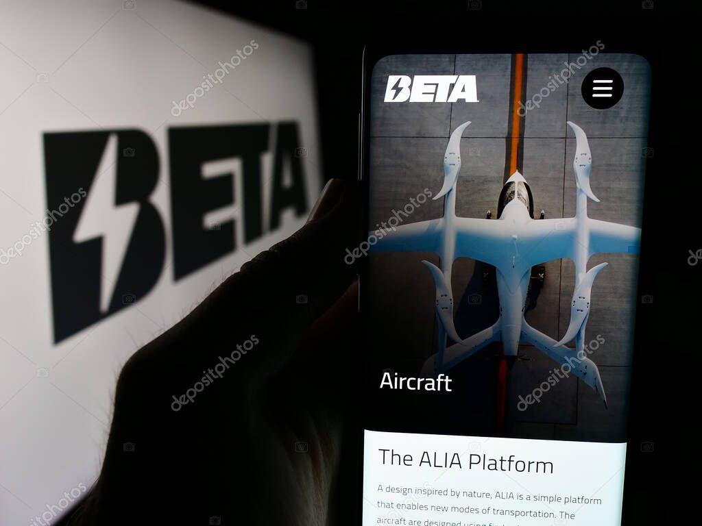 Stuttgart, Germany - 07-14-2024: Person holding smartphone with webpage of US eVTOL aircraft company Beta Technologies Inc. in front of logo. Focus on center of phone display.