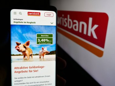 Stuttgart, Almanya - 07-15-2024: Alman finans hizmetleri şirketi Norisbank GmbH 'nin internet sayfası ile logo önünde cep telefonu tutan kişi. Telefon ekranının merkezine odaklan.