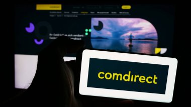 Stuttgart, Almanya - 07-15-2024: Alman finans hizmetleri şirketi Comdirect 'in logosunun bulunduğu cep telefonu sahibi iş sayfası önünde. Telefon ekranına odaklan.
