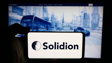 Stuttgart, Almanya - 07-16-2024: ABD 'li batarya materyal şirketi Solidion Technology Inc.' in logosuyla cep telefonu sahibi kişi iş sayfasının önünde. Telefon ekranına odaklan.