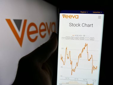 Stuttgart, Almanya - 07-19-2024: İş logosu önünde ABD 'li yazılım şirketi Veeva Systems Inc.' in web sayfası ile cep telefonu tutan kişi. Telefon ekranının merkezine odaklan.