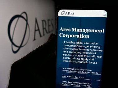 Stuttgart, Almanya - 08-12-2024: ABD 'li yatırım şirketi Ares Management Corporation' ın logo önündeki web sayfası ile cep telefonu tutan kişi. Telefon ekranının merkezine odaklan.