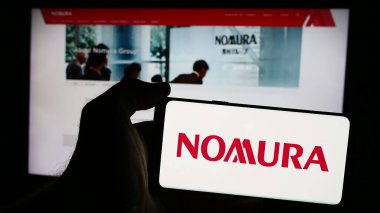 Stuttgart, Almanya - 08-12-2024: Japon finans hizmetleri şirketi Nomura Holding Inc. 'nin logosunun bulunduğu cep telefonu web sayfasının önünde duruyor. Telefon ekranına odaklan.