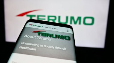 Stuttgart, Germany - 08-13-2024: Mobile phone with website of Japanese medical equipment company Terumo Corporation in front of business logo. Focus on top-left of phone display. clipart