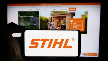 Stuttgart, Almanya - 08-02-2024: Alman elektrik donanım şirketi Stihl Holding AG Co. KG 'nin logosuyla cep telefonu tutan kişi web sayfasının önünde. Telefon ekranına odaklan.