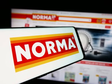 Stuttgart, Almanya - 08-05-2024: Sitenin önünde Norma Lebensmittelfilialbetrieb Co. KG şirketinin logosuna sahip akıllı telefon. Telefon ekranının merkez soluna odaklan.