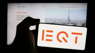 Stuttgart, Almanya - 08-13-2024: İsveçli yatırım yönetim şirketi EQT AB 'nin logosunun bulunduğu cep telefonu sahibi kişi iş sayfasının önünde. Telefon ekranına odaklan.