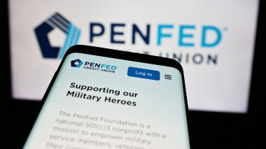 Stuttgart, Germany - 08-19-2024: Mobile phone with website of US company Pentagon Federal Credit Union (PenFed) in front of business logo. Focus on top-left of phone display. clipart