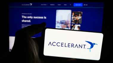 Stuttgart, Germany - 08-19-2024: Person holding smartphone with logo of US risk exchange company Accelerant in front of website. Focus on phone display. clipart