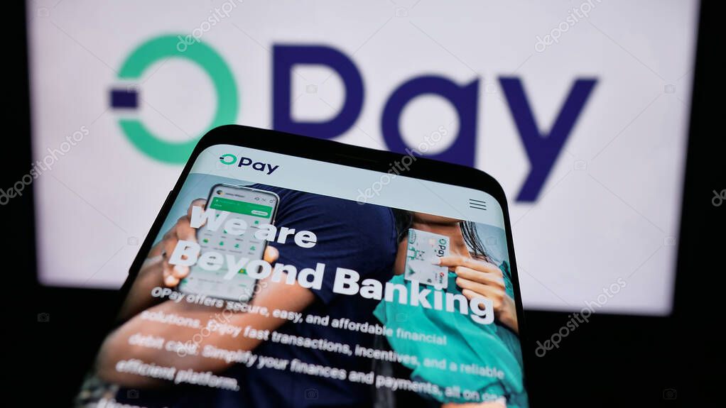 Stuttgart, Germany - 08-26-2024: Mobile phone with website of Nigerian fintech company Opay Digital Services Limited in front of business logo. Focus on top-left of phone display.