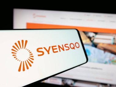 Stuttgart, Germany - 09-29-2024: Smartphone with logo of Belgian materials company Syensqo SA on screen in front of business website. Focus on center-left of phone display. clipart