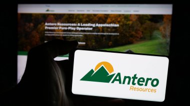 Stuttgart, Germany - 10-08-2024: Person holding smartphone with logo of US company Antero Resources Corporation on screen in front of website. Focus on phone display. clipart