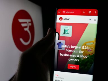 Stuttgart, Almanya - 10-22-2024: Hiveloop Technology Pv. şirketinin web sayfası ile akıllı telefon tutan kişi Ltd. (Udaan) ekranda logolu. Telefon ekranının merkezine odaklan.