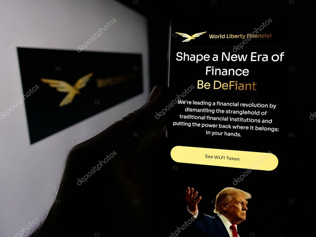 Stuttgart, Germany - 10-22-2024: Person holding cellphone with webpage of US crypto company World Liberty Financial Inc. on screen with logo. Focus on center of phone display.