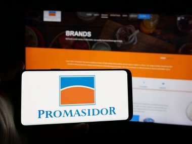 Stuttgart, Almanya - 10-31-2024: İnternet sitesi önünde ekranda, tüketici malları şirketi Promasidor Nijerya Limited 'in logosuna sahip akıllı telefon sahibi kişi görülüyor. Telefon ekranına odaklan.