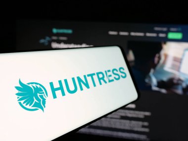 Stuttgart, Almanya - 11-06-2024: Amerikan siber güvenlik şirketi Huntress Labs Inc. 'in logosunu içeren cep telefonu iş sitesinin önünde ekranda. Telefon ekranının soluna odaklan.