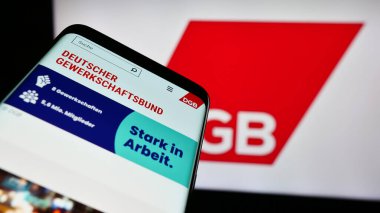 Stuttgart, Almanya - 12-29-2023: Alman örgütü Deutscher Gewerkschaftsbund 'un (DGB) internet sitesiyle birlikte logo önünde cep telefonu. Telefon ekranının sol üst kısmına odaklan.