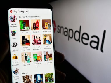 Stuttgart, Almanya - 02-06-2024: Hint e-ticaret şirketi Snapdeal Limited 'in internet sayfası ile cep telefonu tutan kişi logonun önünde. Telefon ekranının merkezine odaklan.