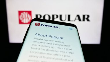 Stuttgart, Almanya - 02-06-2024: Finans hizmetleri şirketi Banco Popular de Puerto Rico 'nun internet sitesiyle birlikte logo önünde cep telefonu. Telefon ekranının sol üst kısmına odaklan.
