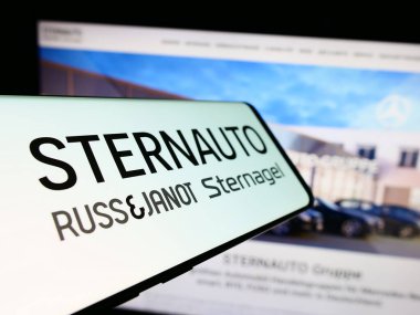 Stuttgart, Germany - 02-15-2024: Mobile phone with logo of German car dealing company Stern Auto Holding GmbH in front of business website. Focus on center-left of phone display. clipart