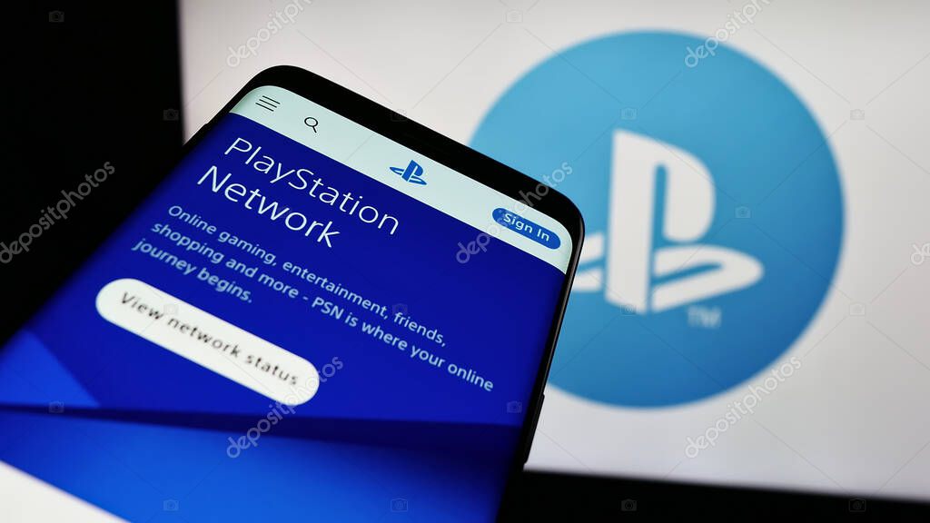 Stuttgart, Germany - 02-14-2024: Smartphone with website of video gaming platform PlayStation Network (PSN) in front of business logo. Focus on top-left of phone display.