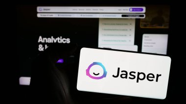 Stuttgart, Almanya - 02-16-2024: Amerikan yapay zeka şirketi Jasper Al Inc. 'in logosunun bulunduğu cep telefonu web sayfasının önünde duruyor. Telefon ekranına odaklan.