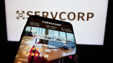 Stuttgart, Germany - 02-24-2024: Mobile phone with website of Australian workspace solutions company Servcorp Limited in front of logo. Focus on top-left of phone display. clipart