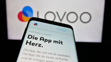 Stuttgart, Almanya - 02-26-2024: İş logosu önünde Alman online flört platformu LOVOO 'nun web sitesine sahip akıllı telefon. Telefon ekranının sol üst kısmına odaklan.