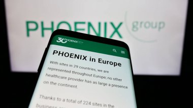 Stuttgart, Almanya - 03-01-2024: Alman ilaç firması PHOENIX Pharmahandel 'in web sitesine sahip akıllı telefon. Telefon ekranının sol üst kısmına odaklan.