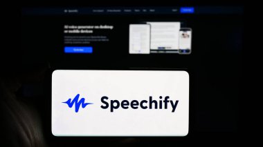 Stuttgart, Germany - 03-10-2024: Person holding cellphone with logo of text-to-speech app company Speechify Inc. in front of business webpage. Focus on phone display. clipart