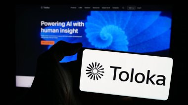 Stuttgart, Almanya - 03-25-2024: İnternet sitesinin önünde yapay istihbarat şirketi Toloka AI BV 'nin logosuna sahip kişi. Telefon ekranına odaklan.